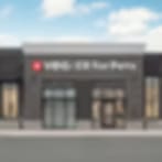 Small blurry image of a wide low building with a dark band and a sign above glass doors