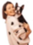 Smiling person in a pale sweater holding a small black and white dog on a white background