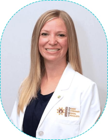 Smiling woman with long blonde hair in a white coat with a paw logo in an oval frame