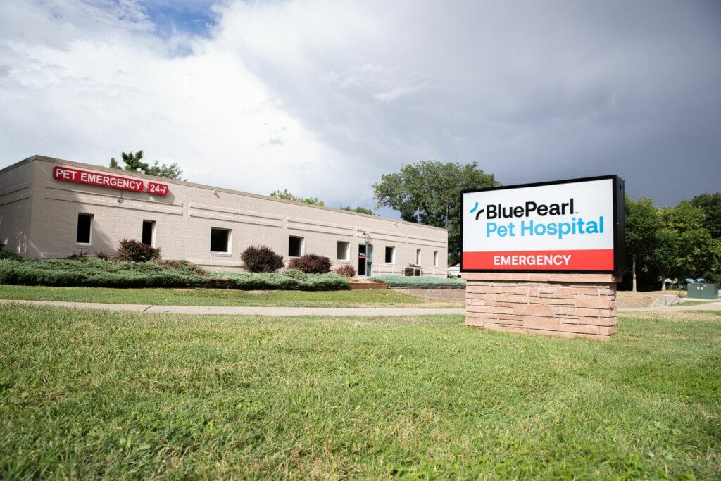 BluePearl Pet Hospital emergency building with a lawn and a sign under a cloudy sky