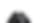 Tiny dark gray smudge image with no recognizable subject