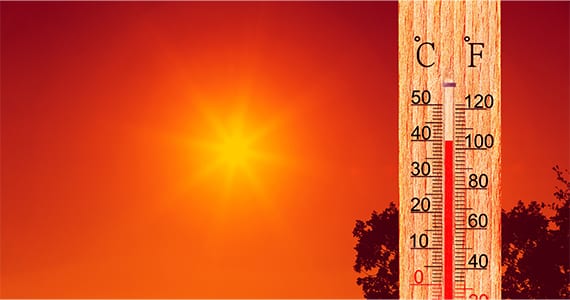 Illustration of a thermometer showing high temperature in front of a bright orange sun