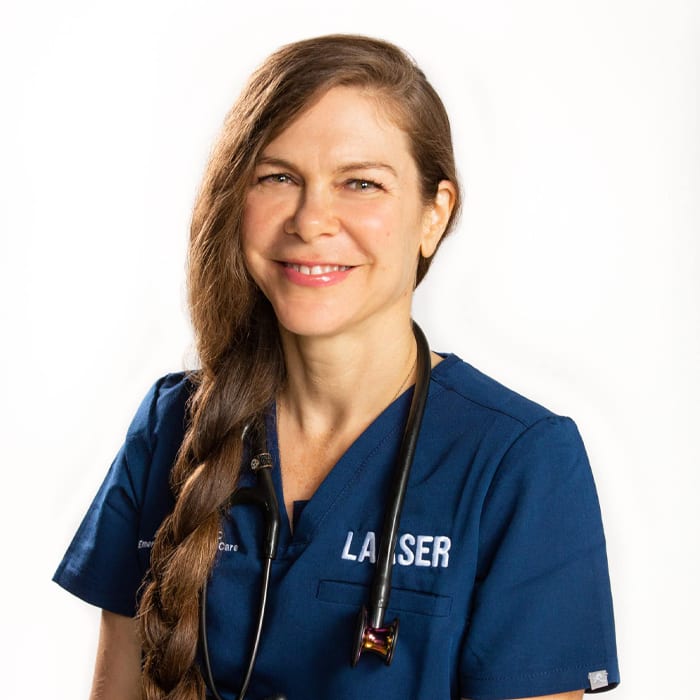Smiling woman with a long brown braid in navy LAASER scrubs and a stethoscope