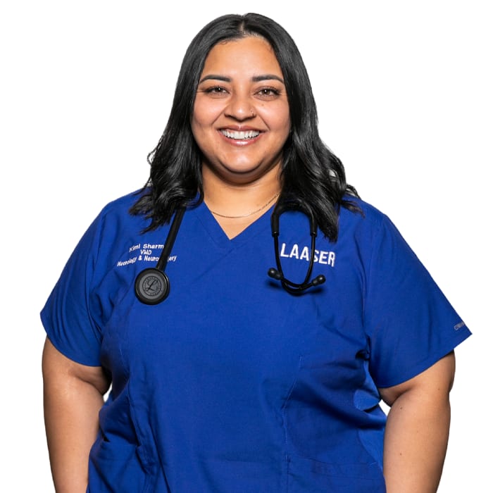 Smiling woman with long dark hair in royal blue scrubs with a stethoscope