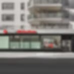 Very blurry low-resolution image of a street-level storefront with a dark roofline