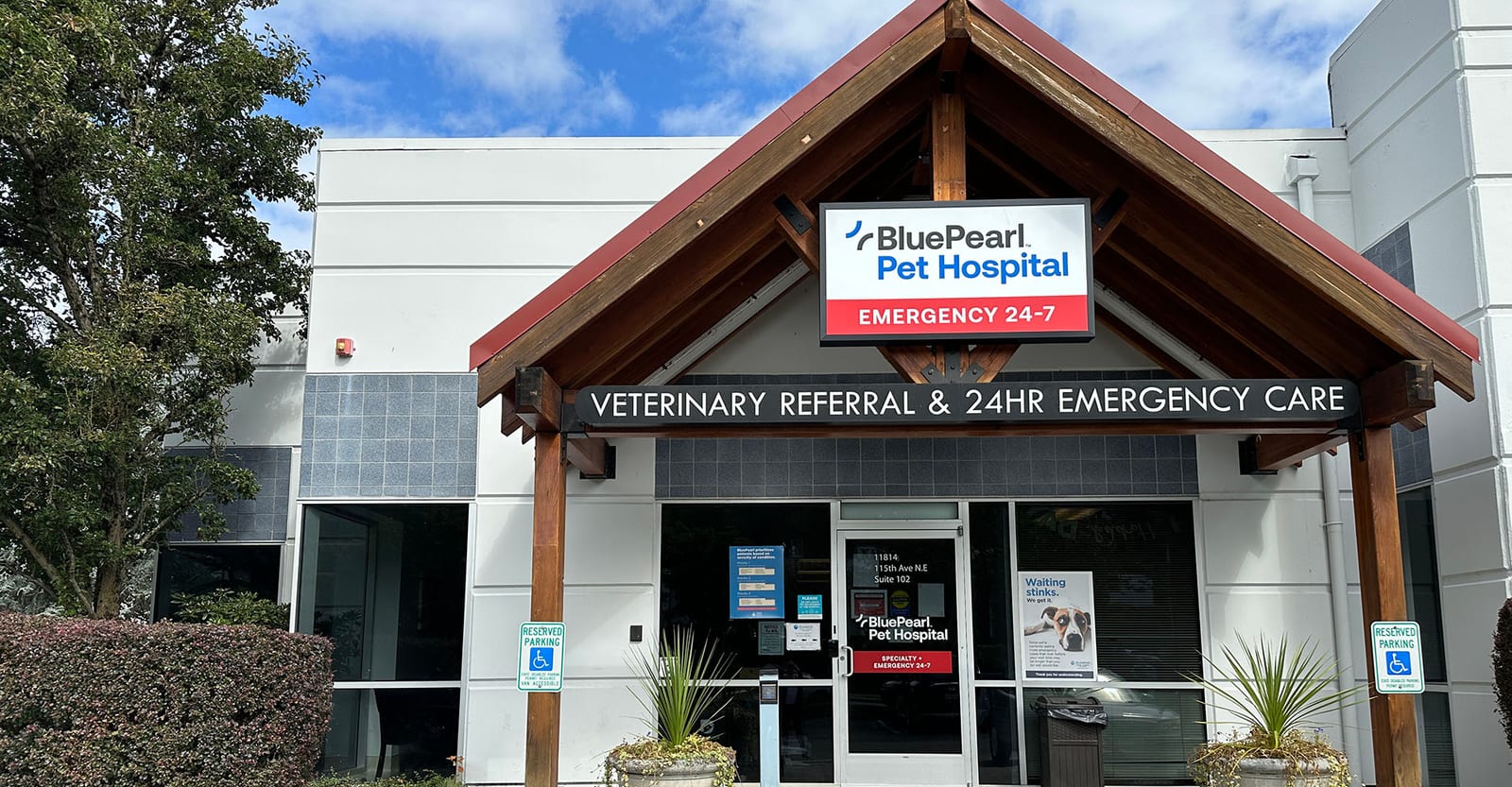 BluePearl Pet Hospital building with a gabled wooden entrance and a veterinary referral and emergency care sign